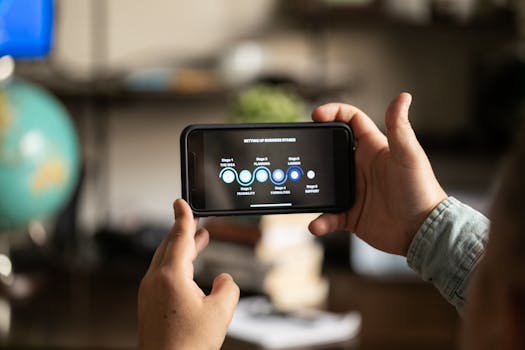 Hands holding a smartphone displaying business stages in a cozy indoor setting.